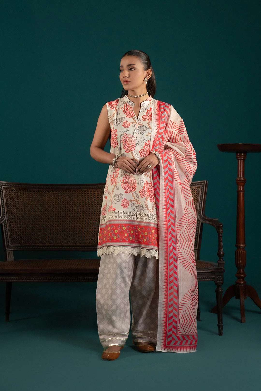 Trendy lawn suit design featuring an off-white printed shirt with cherry red details, paired with a matching monark dupatta and cambric trousers.