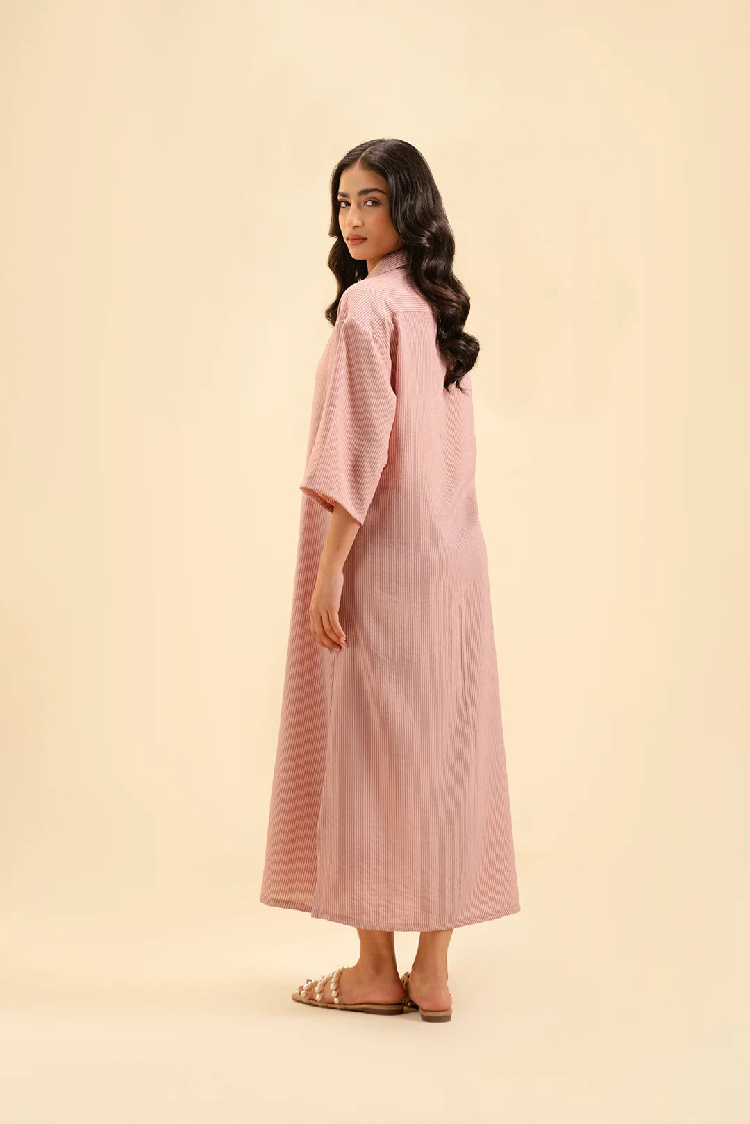 Trendy pastel pink dress with elbow-length sleeves – modern fashion style.