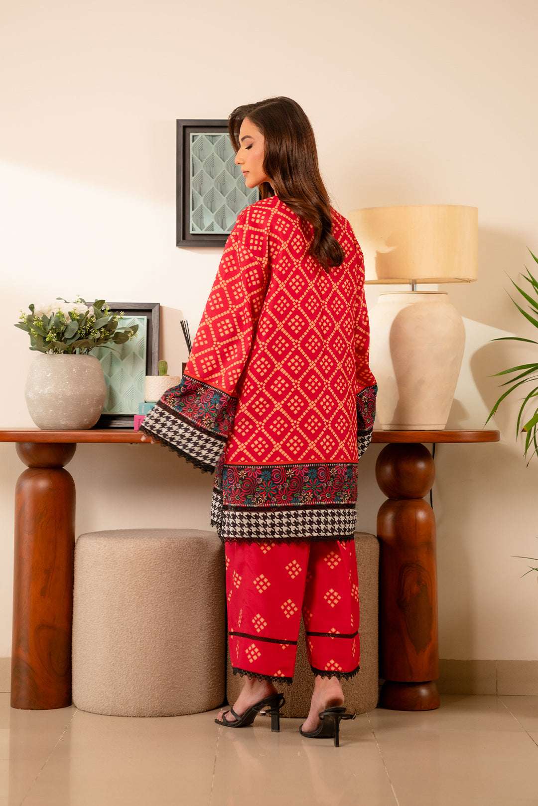 Unstitched cambric suit for women – vibrant red base with contrasting ethnic print, perfect for summer styling.