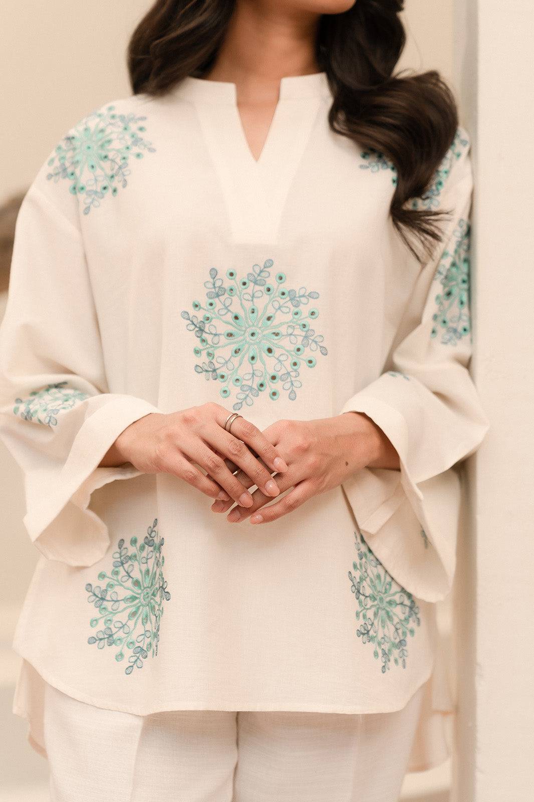 Upgrade your wardrobe with an off-white embroidered khaddar shirt, perfect for stylish winter wear