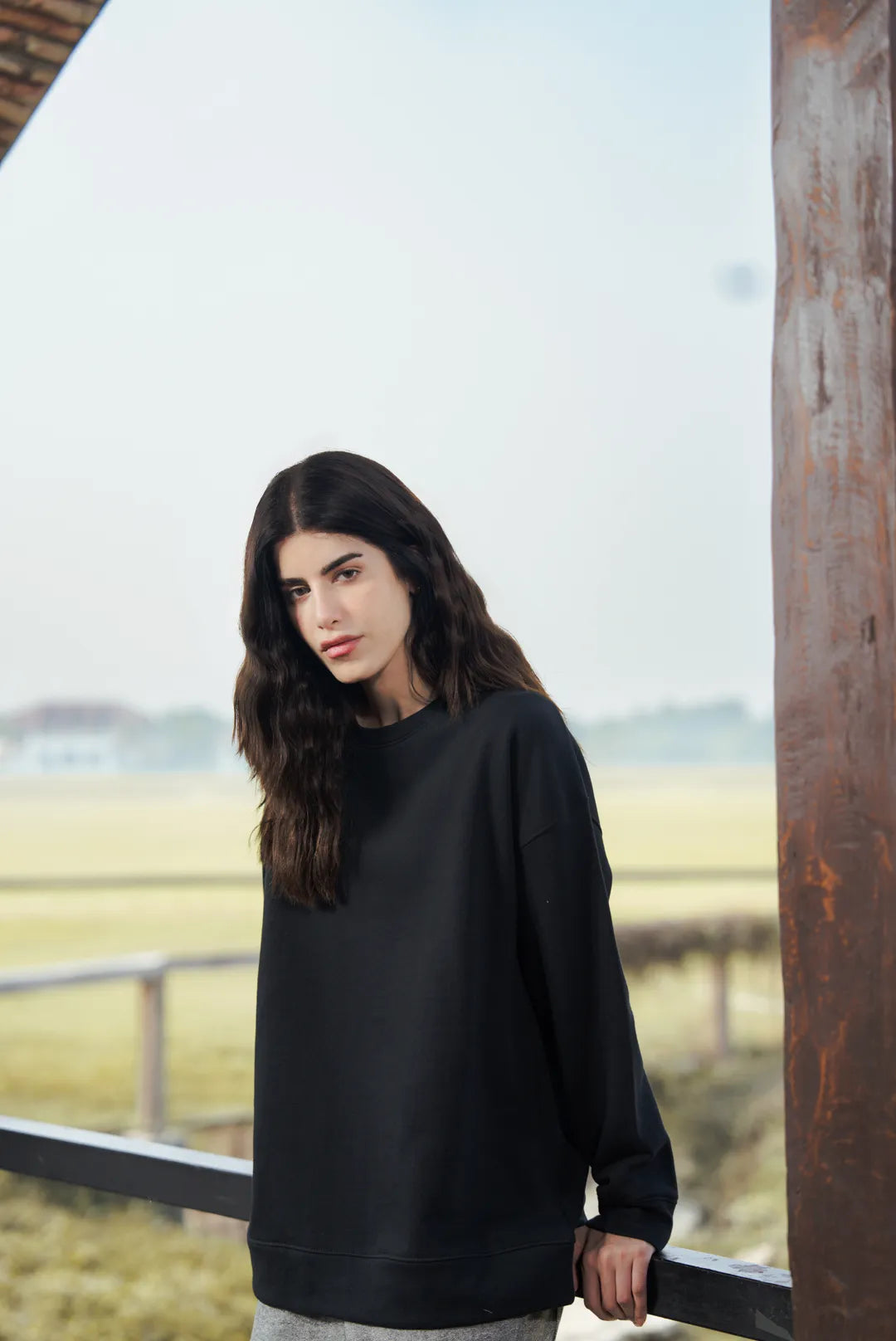 Upper body view of black sweatshirt relaxed styling