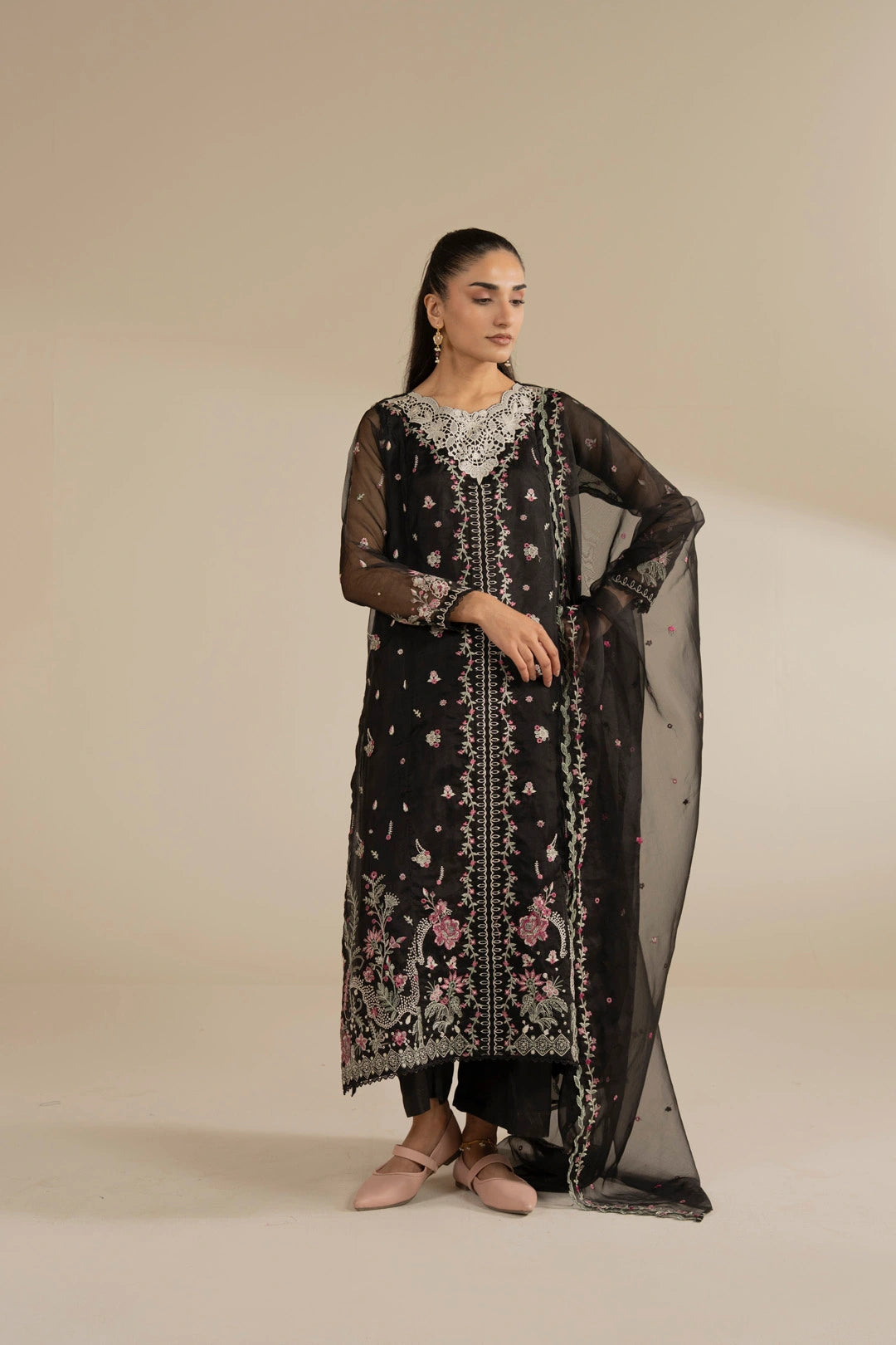 Wedding-ready black organza suit styled with sheer dupatta, showing elegant overall drape.