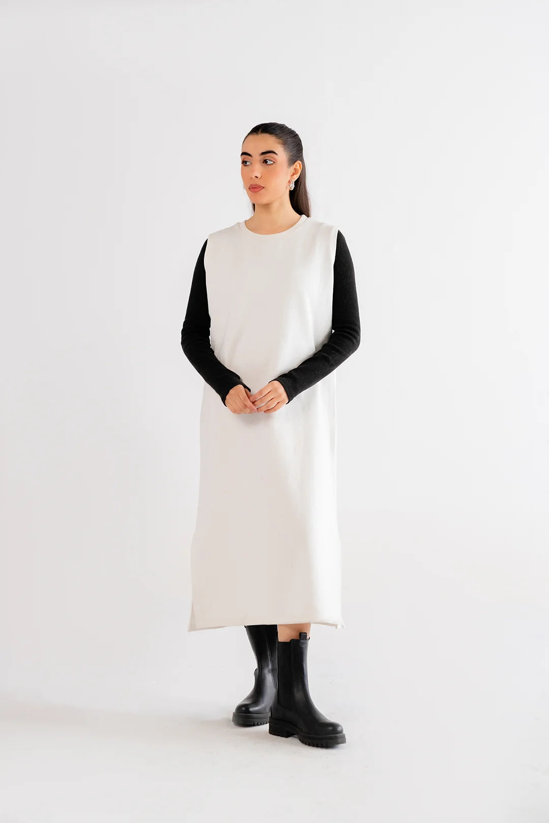 White maxi dress styled with black details, showcasing a versatile and trendy outfit idea.
