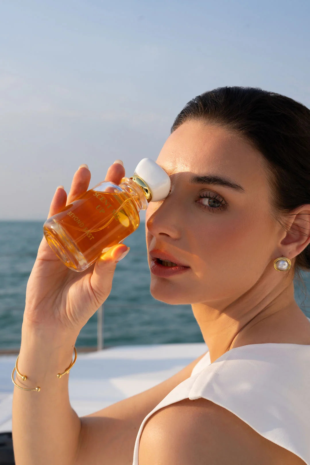 Woman applying Scent Me Up perfume - Oriental fragrance for special occasions