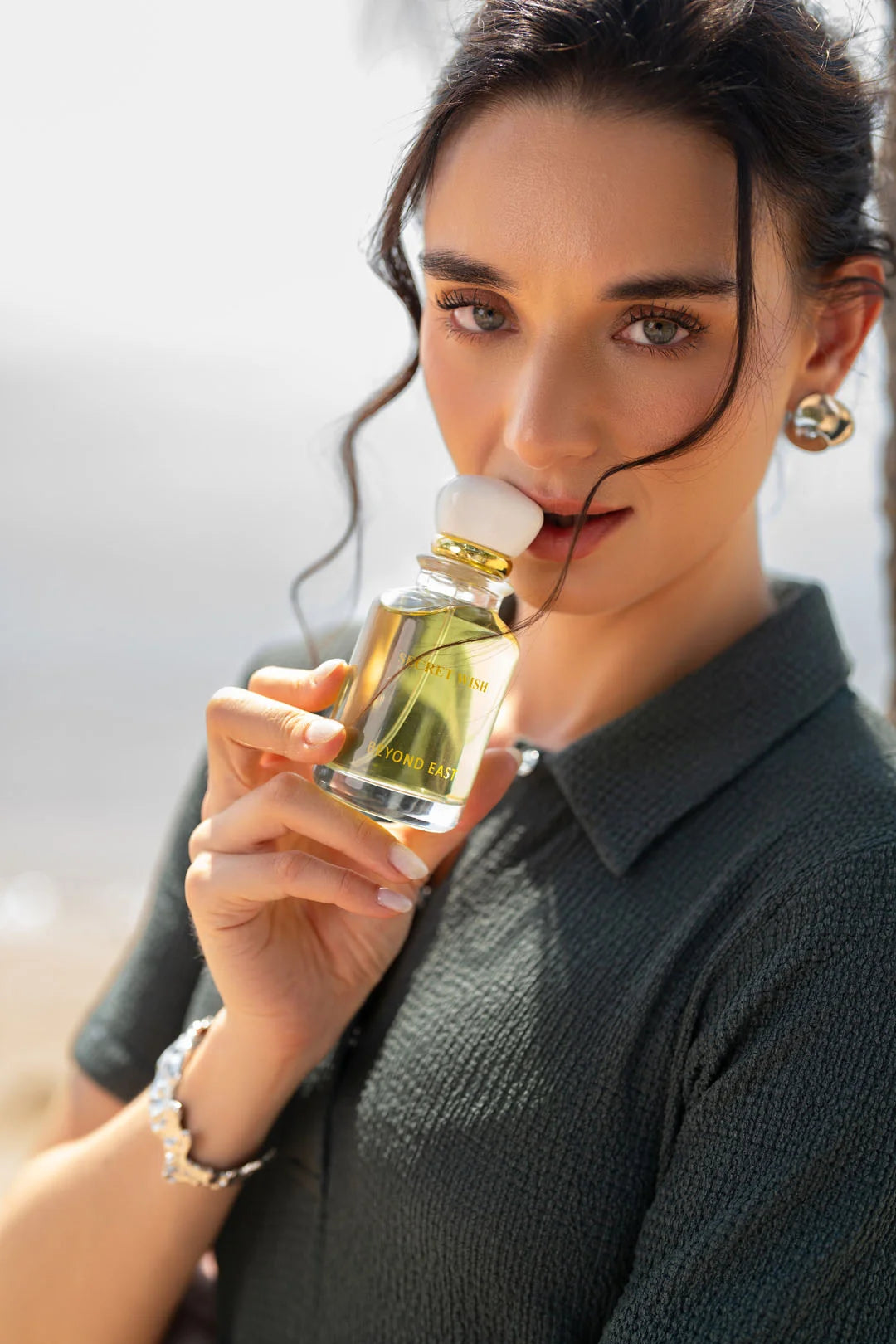 Woman applying Secret Wish perfume - Sweet vanilla caramel fragrance