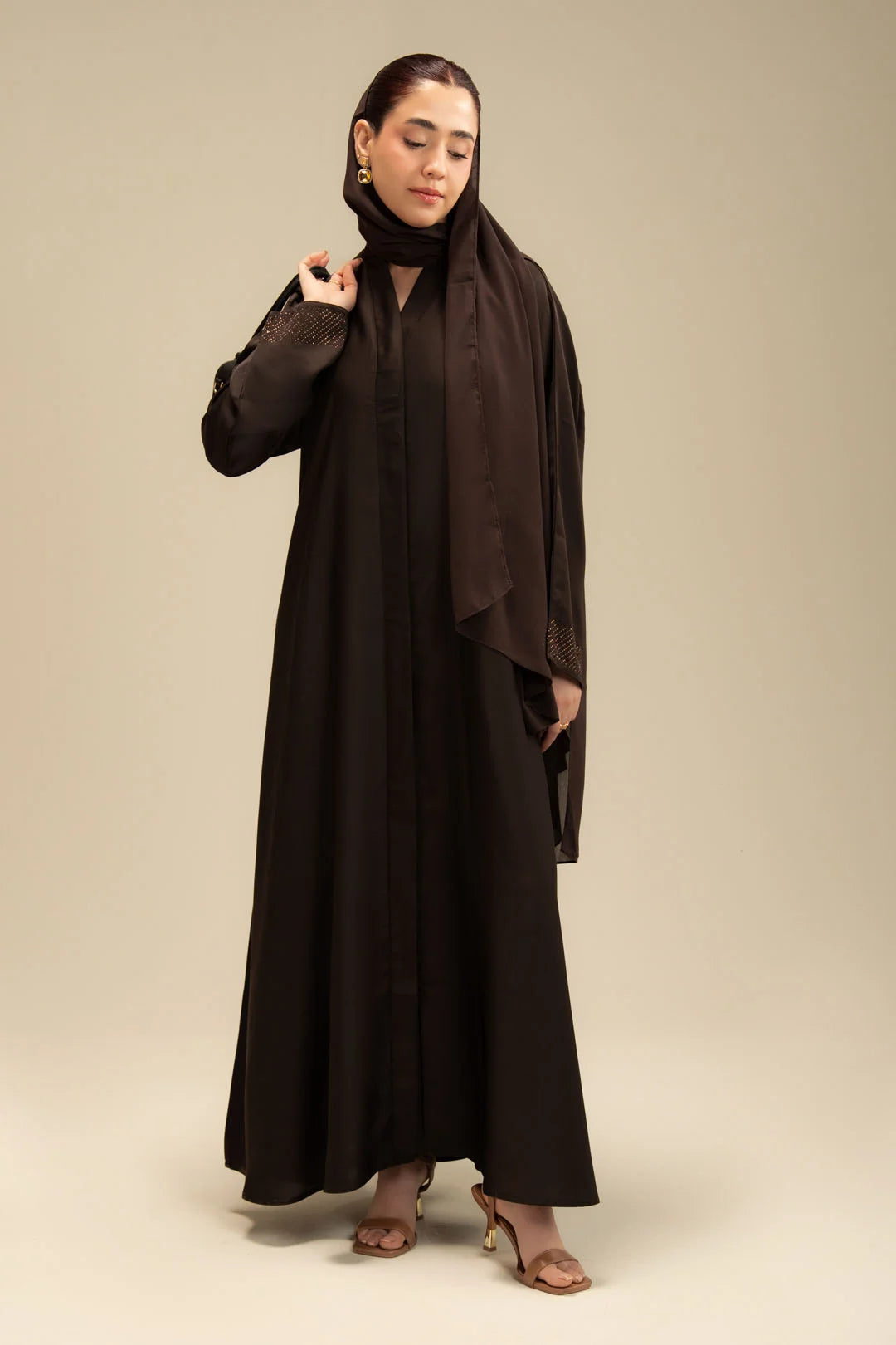 Woman wearing dark brown full-length abaya – graceful modest fashion Beyond East