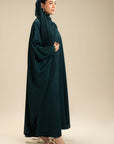 Woman wearing emerald green abaya – new abaya style modest wear Beyond East