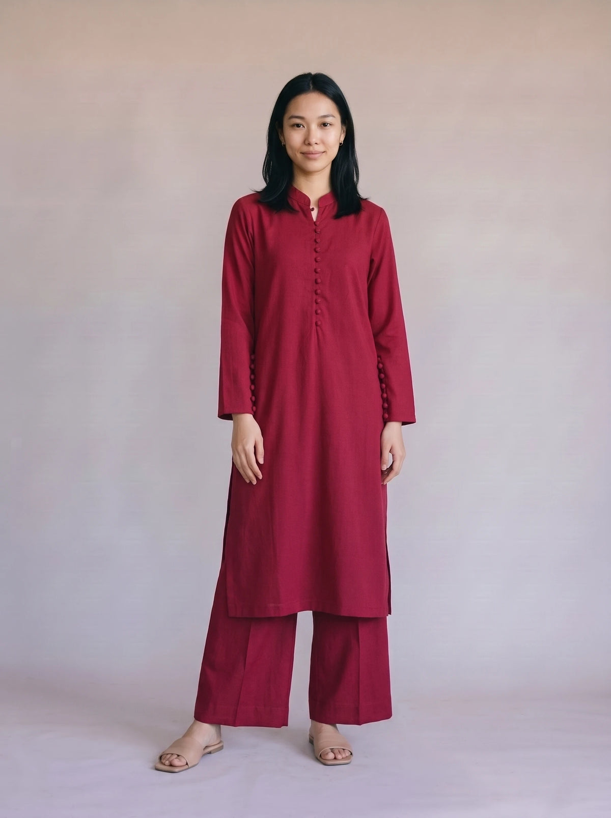 Woman wearing a solid maroon co-ord set with wide leg palazzo trousers and matching kurta top from Beyond East Pakistani fashion collection