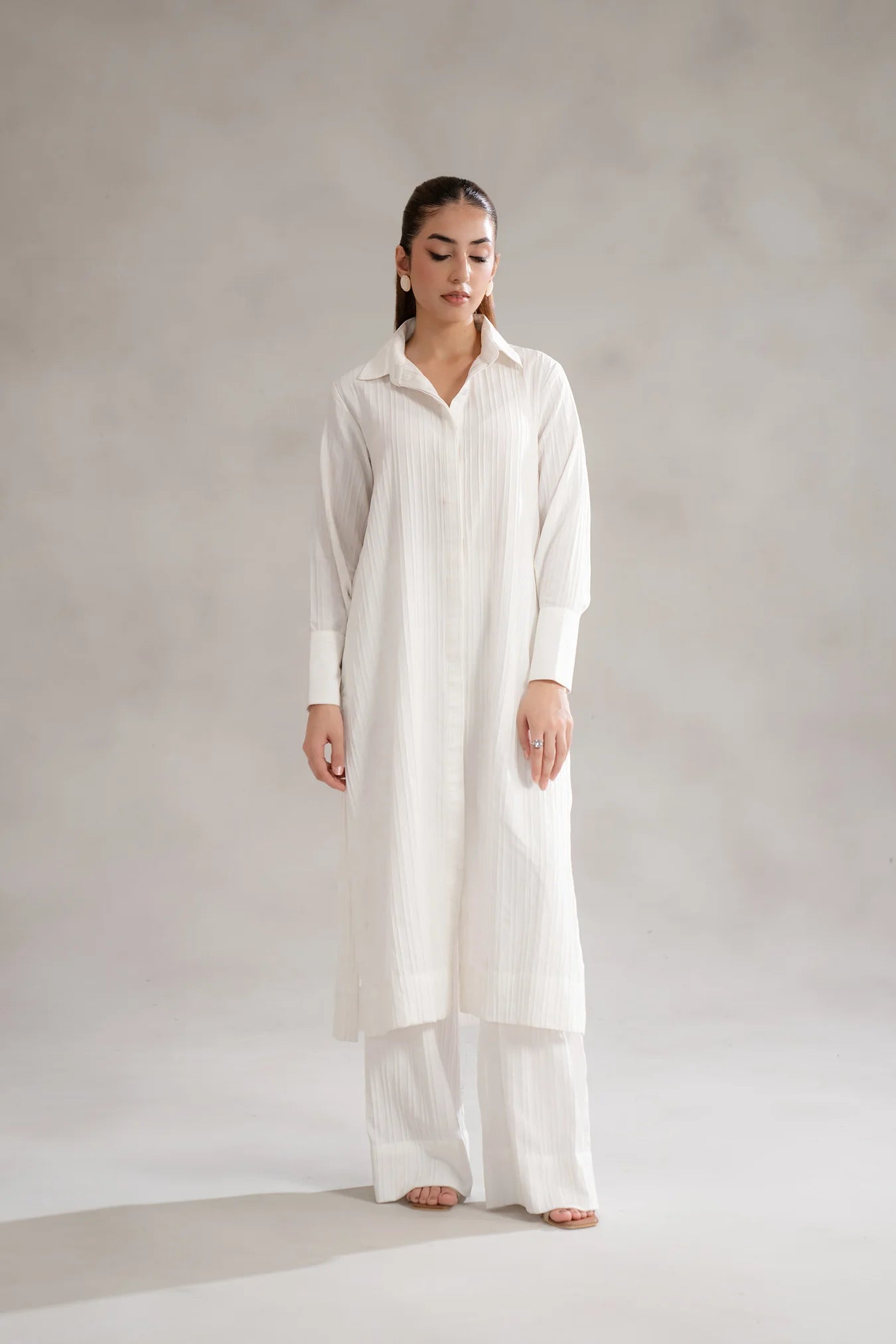 white button-down shirt with a classic collar, and wide-leg trousers