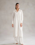 white button-down shirt with a classic collar, and wide-leg trousers